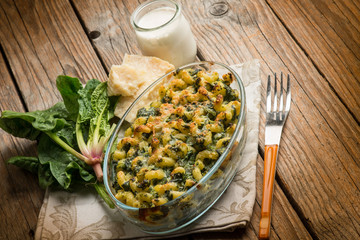 oven pasta with spinach cream sauce and parmesan cheese