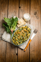 oven pasta with spinach cream sauce and parmesan cheese