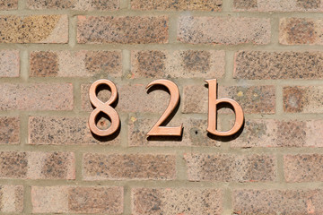House Number 82B sign on wall