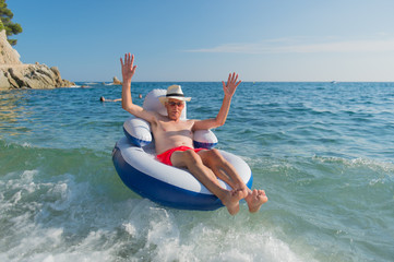 Senior man floating in sea