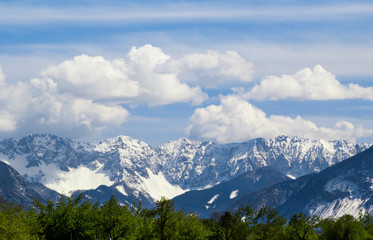 Fototapeta premium Mountain peaks snow and clouds background