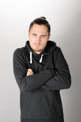 Confident young man posing on gray background