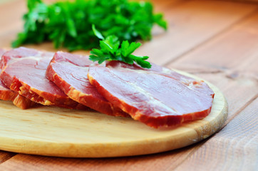 Jerky and parsley on a wooden cutting board