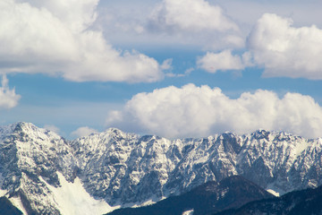 Fototapeta na wymiar Mountain peaks snow and clouds background