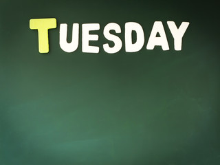 Wooden Tuesday on Green Board. Wood Tuesday word on blackboard with copy space.