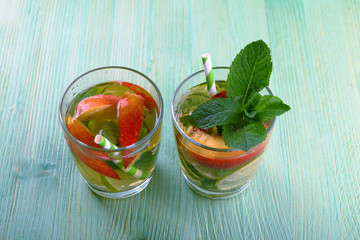 lemonade with lime and ice on a wooden background