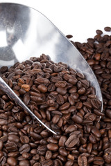 metal scooper on coffee beans