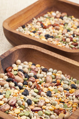 two wooden bowls of assorted beans