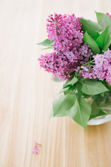 lilac bouquet transparent round vase light room day lighting