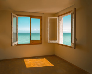 Empty room with two windows opened to the Mediterranean sea in Sitges, Barcelona, Spain..Photo taken on 9th August 2007