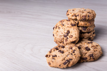 chocolate chip cookies stacked on wooden table background