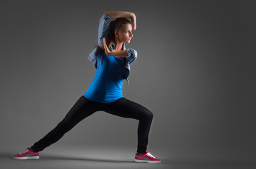 Fototapeta premium modern dancer poses in front of the studio background