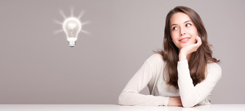 Young woman next to creativity symbol.