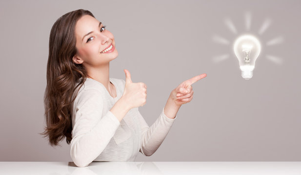 Young woman next to creativity symbol.