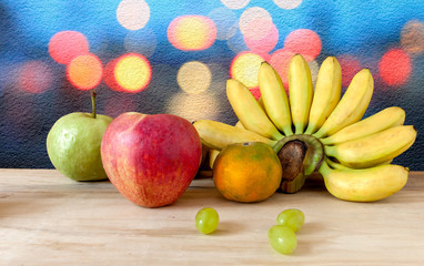 Fresh fruit apple grapes banana and grange with background