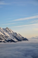 mountain peak with cloud hood and fog
