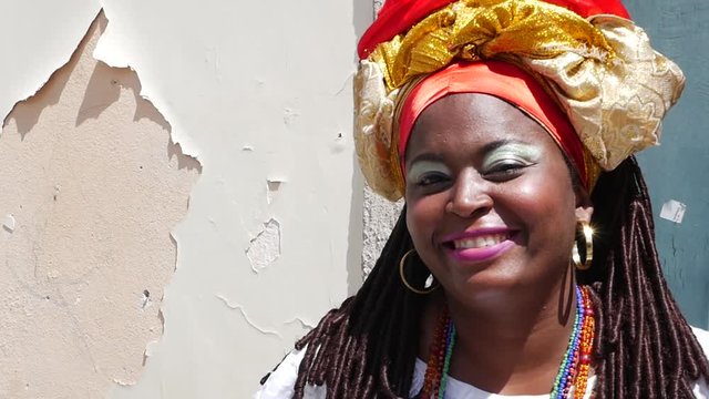 Brazilian woman of African descent wearing traditional clothes from the state of Bahia in the old colonial district of Salvador (Pelourinho), Brazil