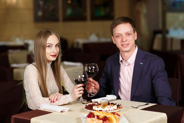 Couple toasting wineglasses in a luxury restaurant.