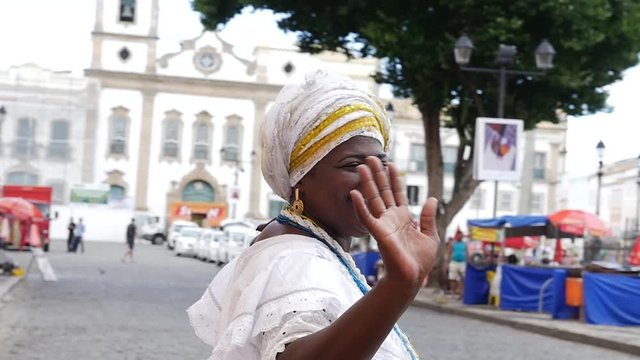 Brazilian woman of African descent wearing traditional clothes from the state of Bahia in the old colonial district of Salvador (Pelourinho), Brazil