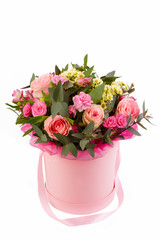 bouquet of beautiful colorful flowers on isolated background in the hat basket