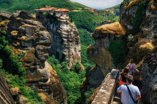 Fototapeta People go on the background of The Holy Monastery of Varlaam. Meteora monasteries, Greece