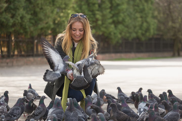 photo of Girl and doves.  feeding pigeons in the park