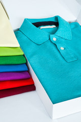 Luxurious fine material 100% cotton polo shirt displayed in a gift box with a pile of another polo...