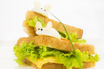 toast with cheese decorated with white mice of quail eggs