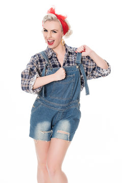 Beautiful happy retro woman in plaid shirt and bib overalls isol