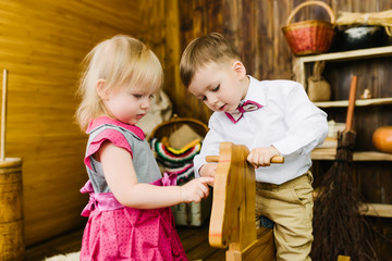 Children riding on a wooden horse