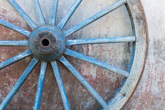 Part of old ironed blue wagon or carriage wheel