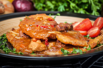 Potato pancakes with meat stew served on a plate.