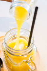 Poring passionfruit juice - motion blur
