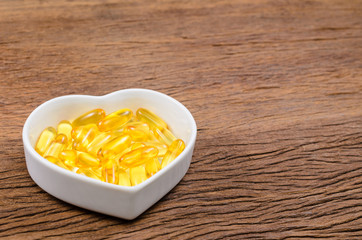 fish oil in heart shape bowl