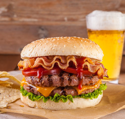 Bacon and cheese burger with grilled beef patty. tomato and onio