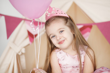 Kid girl wearing pink crown celebrating her birthday