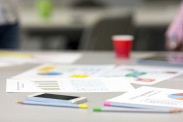 Grey Office Table with Paper Charts and Stationery