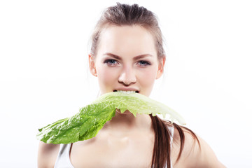 Attractive woman is biting lettuce