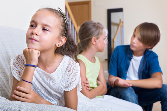child sitting aside of boy and girl