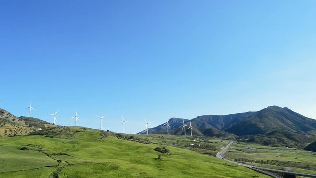 Landscape of wind turbines energy renewable at green field in the mountains at sunny day