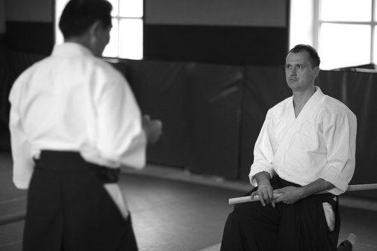 Martial arts school; student listening to sensei