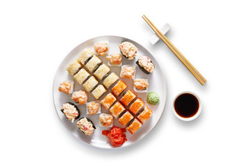 Set of sushi maki and rolls at black rustic wood.