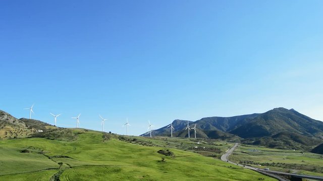 Landscape of wind turbines energy renewable at green field in the mountains at sunny day