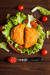 chicken cutlets with cherry tomatoes and lettuce