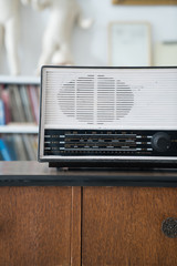 radio on wooden table and bookshelf background