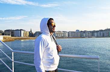 Young man looking at the sea in San Sebastian, Spain