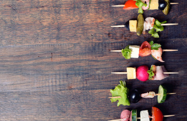 skewers on wooden background