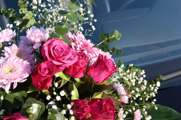 Flowers bouquet on the car. Wedding ceremony. Roses