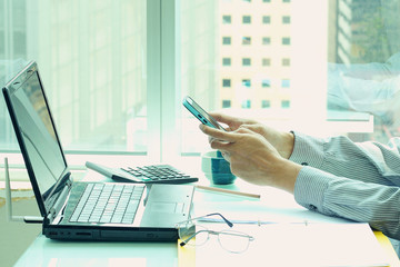 Business Man working in office and using smart phone