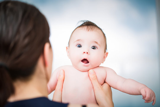 Newborn Baby With Funny Suprised Face Expression.